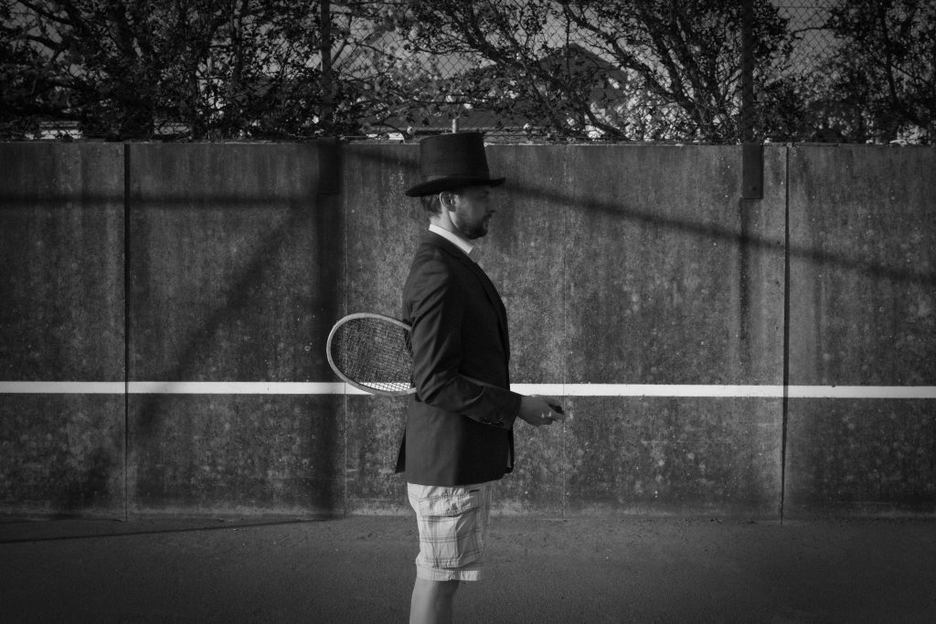 Man with Hat - Tennis Court