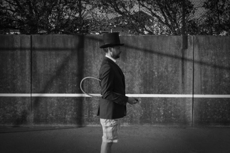 Man with Hat – Tennis Court 1