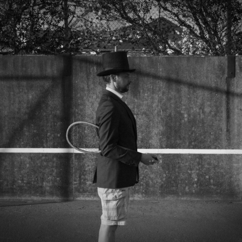 Man with Hat - Tennis Court